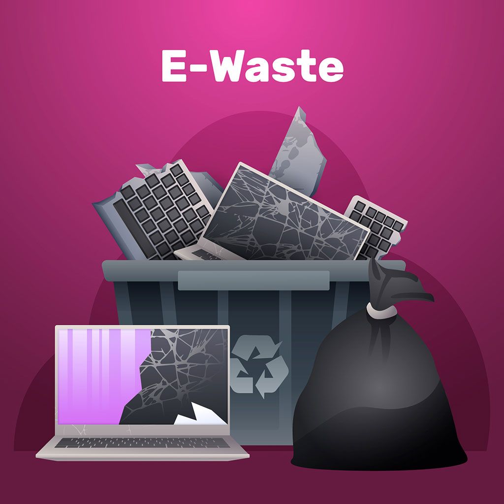 E-waste bin overflowing with broken electronic devices including a laptop and a keyboard